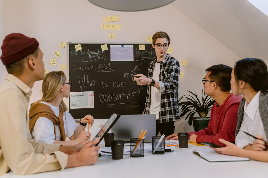 Young professionals discuss consumer strategies in a collaborative office meeting.